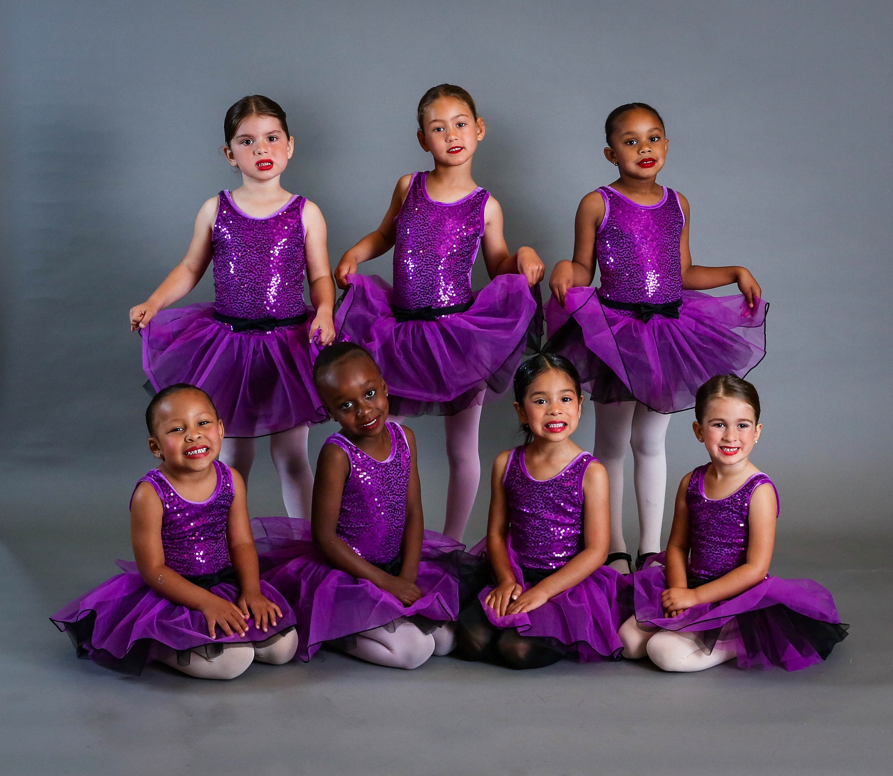 Dance company group in performance costumes