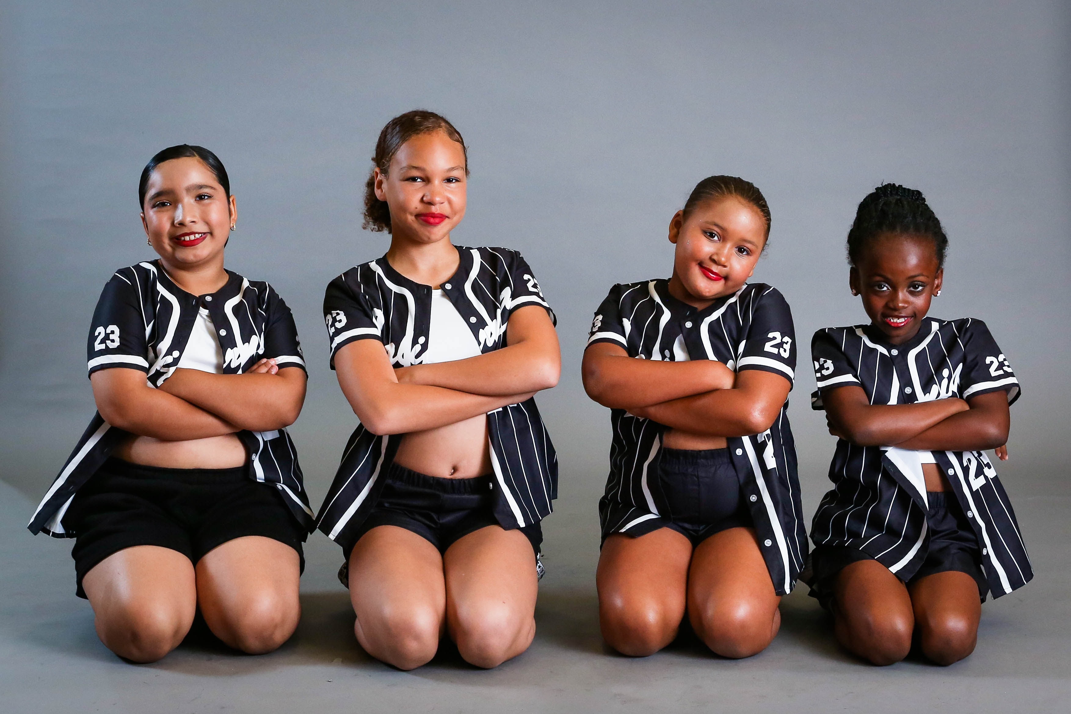 Young dancers in pink and teal costumes