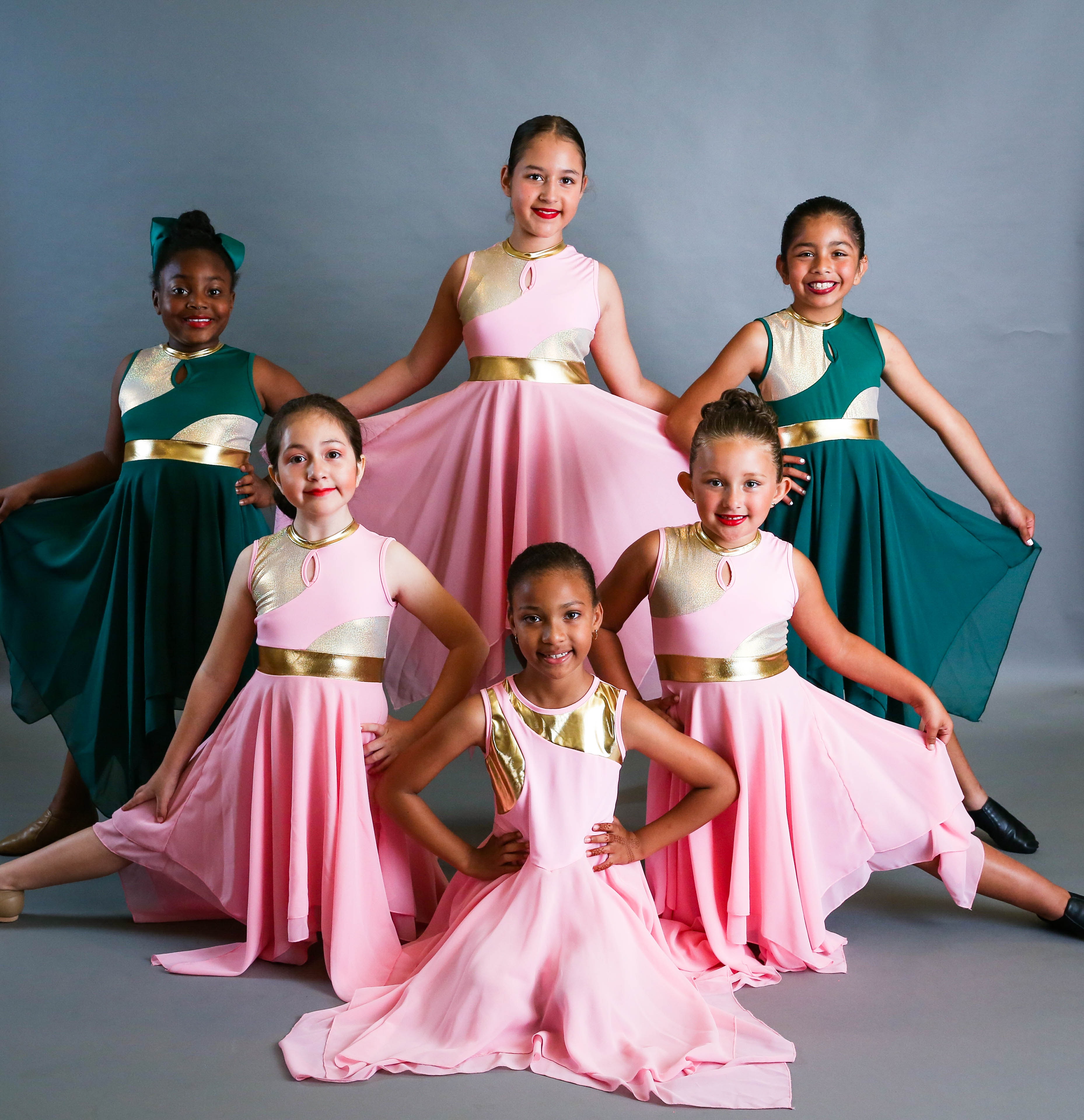 Young dancers in pink and teal dresses